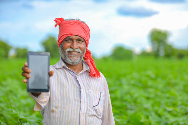 istock Indian farmer Showing a mobile screen at agriculture field 1279933404