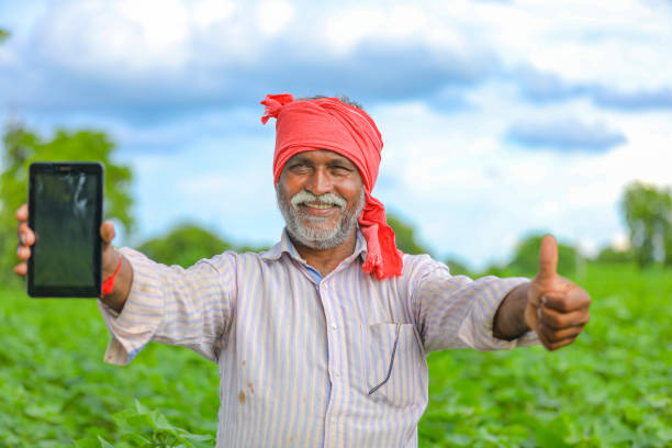 istock Indian farmer Showing a mobile screen at agriculture field 1279933445