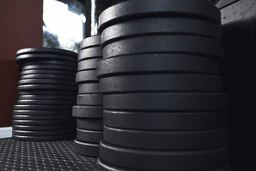 Still life shot of weight plates in a gym