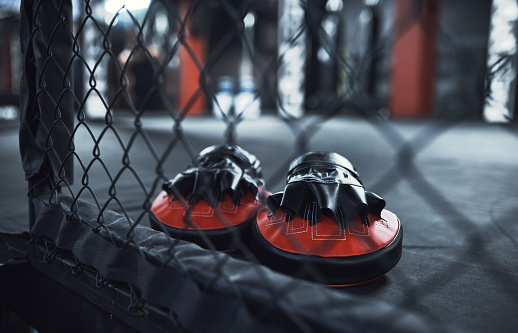 Still life shot of a pair of boxing mitts in a gym