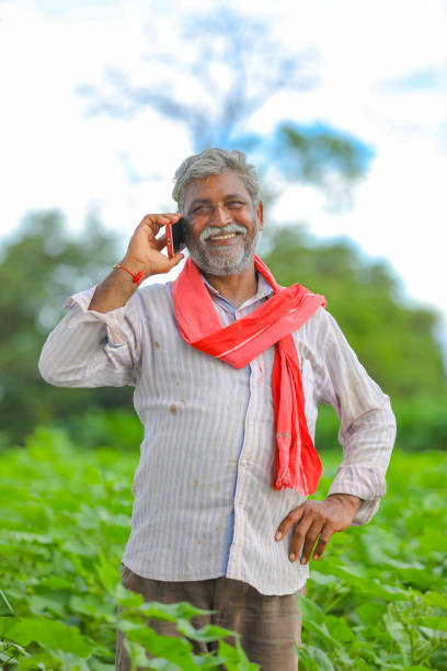 istock Indian farmer talking mobile phone at Agriculture field 1279933635