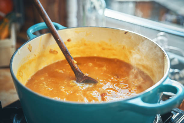 istock Preparing Pumpkin Soup with Baked Pumpkins and Bacon 1279934336