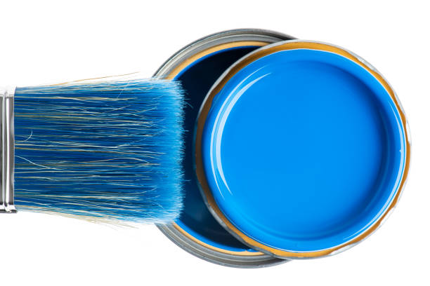 istock Paintbrush and open can of paint close-up directly above on white 1279934421