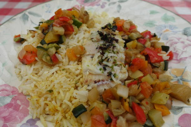 istock Fillet cod cooked with aromatics  Sea fish served with mixed vegetables and saffron rice 1279934507