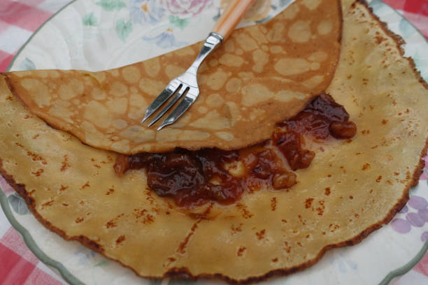 Sweet crepe served with jam made from figs, grapes and walnuts French cuisine Tradition by candlelight Sweet crepe served with jam made from figs, grapes and walnuts French cuisine Tradition by candlelight candlemas stock pictures, royalty-free photos & images