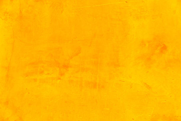 fragment der gelben zementwand als hintergrund für text und design - orange wall textured paint stock-fotos und bilder