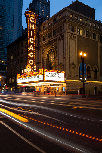 Chicago, USA - Mar 12, 2020: Early in the evening the Chicago Theater with vehicles passing by.