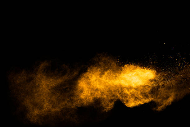 istock Freeze motion of yellow orange dust particles splash 1279935740