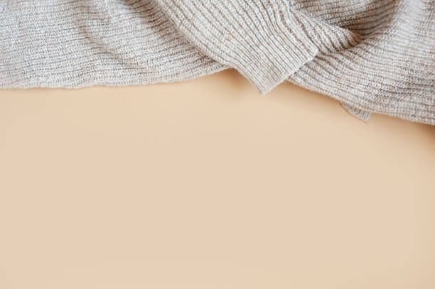 istock cozy large-knit wool sweater on a clean beige background, beige monochrome 1279936470