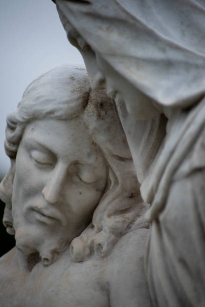 Face of Jesus on Victorian cemetery statue. Beautiful stone pieta in a Victorian cemetery. Full frame image in natural light. Selective focus on face of Jesus. pieta stock pictures, royalty-free photos & images