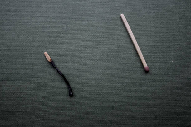 Two matches burning together resembling a couple