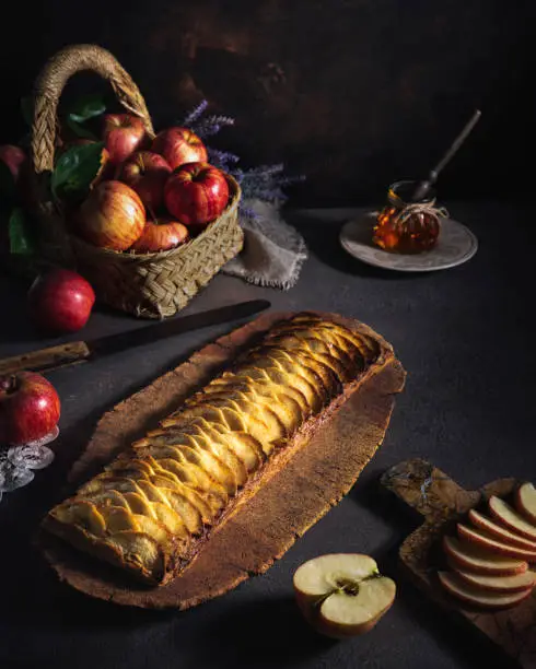 Apple puff pastry pie rectangular with apples basket and apple fruit slices preparation