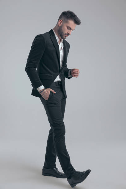 istock Thoughtful elegant man holding hand in pocket and wearing suit 1279940882