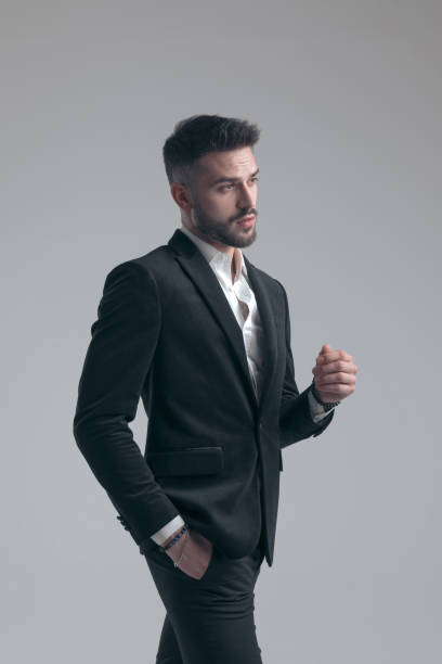 istock Eager elegant man holding hand in pocket, wearing suit 1279941617