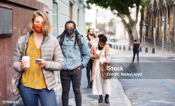 Group Of Diverse People In Face Masks Social Distancing On A City Sidewalk Stock Photo - Download Image Now