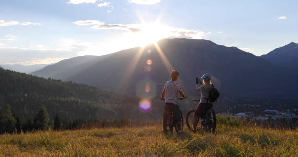 istock Mountain e-biking couple relax in alpine meadow 1279943388