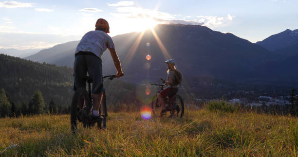 istock Mountain e-biking couple ride through alpine meadow 1279944088