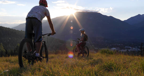 istock Mountain e-biking couple ride through alpine meadow 1279944121