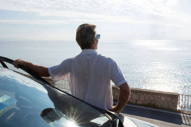 istock Mature man relaxes beside car door 1279945369