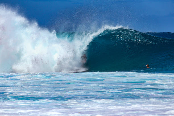 istock Powerful blue wave barrelling over a body boarder 1279945497