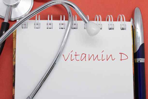 istock Vitamin D medicine concept, lettering in notebook, stethoscope, pen on a red background. 1279947205