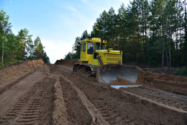 istock Dozer during clearing forest for construction new road . Yellow Bulldozer at forestry work Earth-moving equipment at road work 1279948278
