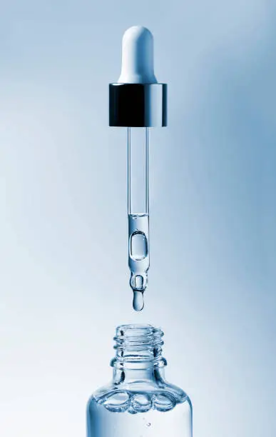 Cosmetic pipette with hyaluronic acid. Transparent gel with bubbles close-up. Gel cream or serum. A sample of a cosmetic product. Antibacterial gel.