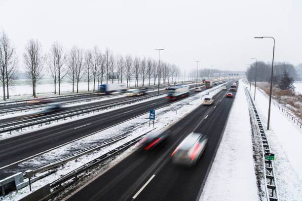 Moving traffic on a highway during a snow blizzard in winter