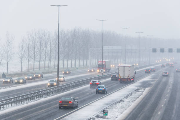 istock Moving traffic on a highway during a snow blizzard in winter 1279952686