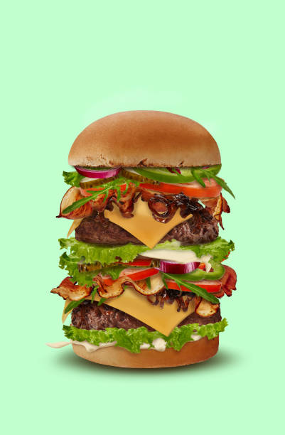 istock Tasty big double burger against light green background. Ham, beef cutlet, cheese, sauces, vegetables and greens. Close up, copy space 1279953540