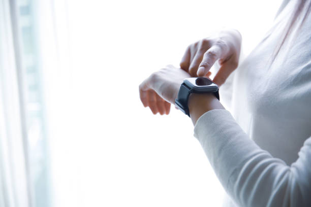 istock Women's hands in white clothes, operating a smartwatch on a white background 1279955899