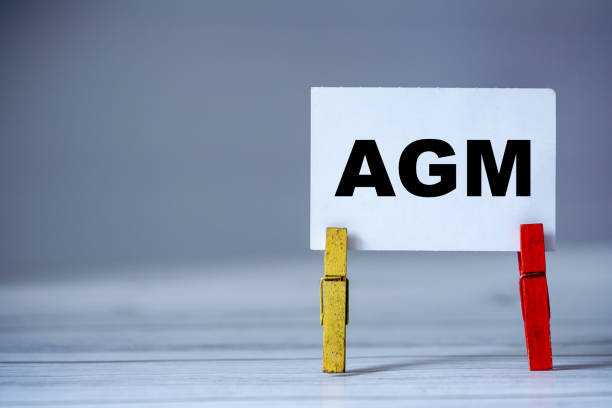 istock Reminder sticky note with clothes pin on table. Sticky note with word AGM. Business strategy 1279956920