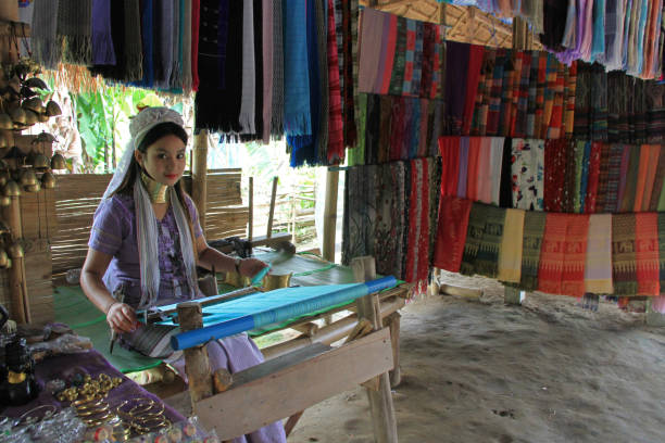 Chiang rai, Thailand - 15 Mai 2018 :  Karen tribal girl making scarfs,  near Mae Hong Son, Thailand, Chiang Rai. Padaung long neck hill tribe village, refugee community originate from neighboring Myanmar.
