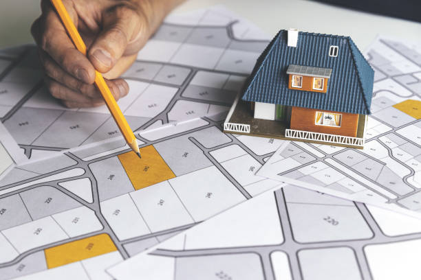 istock choose a building plot of land for house construction on cadastral map 1279961140