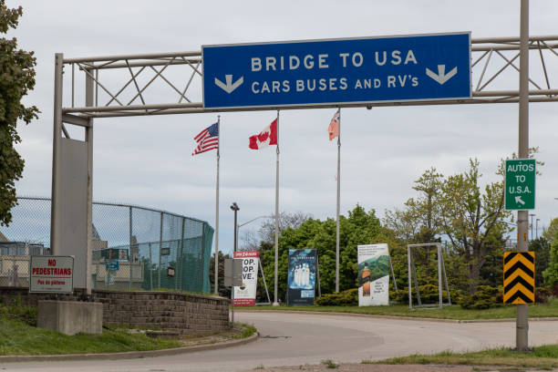 Empty Windsor Bridge Entrance to the US-Canada Border During the Coronavirus Pandemic An empty Bridge to USA, entrance to the US-Canada border seen during the travel restrictions due to COVID-19. (Windsor, Ontario) bridge crossing cloud built structure stock pictures, royalty-free photos & images