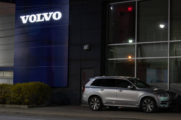 Volvo Dealership at Night with their XC90 SUV Volvo XC90 parked out-front of a Volvo Dealership in downtown Toronto. Volvo text logo on the building glowing at night. volvo photos stock pictures, royalty-free photos & images