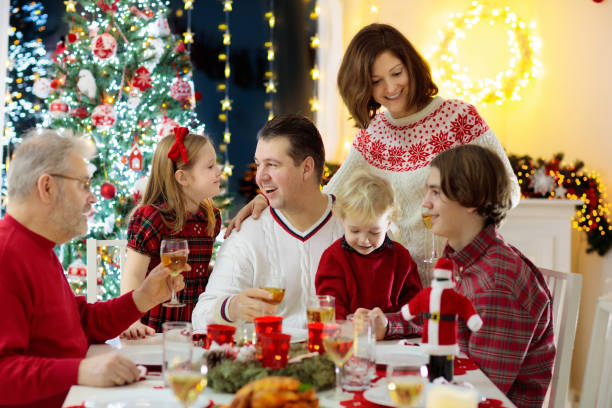 istock Family with kids having Christmas dinner at tree 1279962507