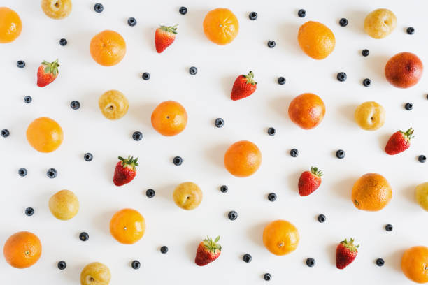 istock Fruits and berries on white background, overhead view. Fruit pattern. Yellow plum, strawberry, blueberry and orange 1279963611