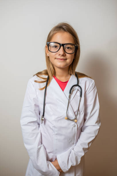 istock Cute child in doctor coat with stethoscope on white background. Space for text 1279963644