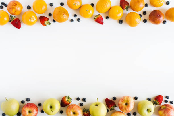 istock Food frame background. Fruits and berries on white table, top view, space for text. Oranges, apples, strawberry, blueberry layout 1279963864