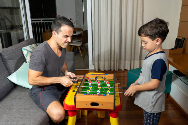 istock Father and son playing mini foosball at home_Photo 4. 1279965183