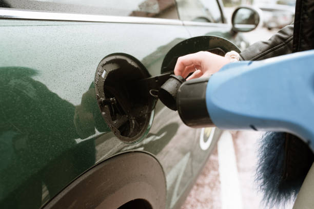 istock Young woman charging her electric car 1279967201