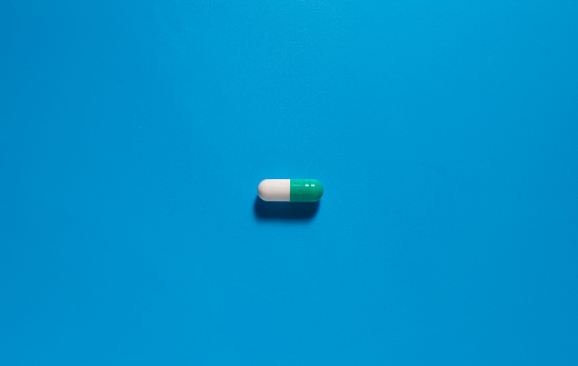 Single pill on blue background