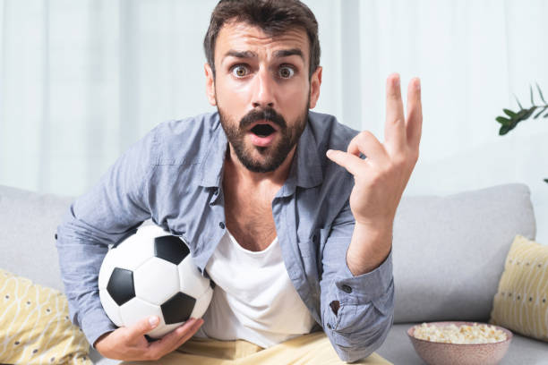 istock Young man shocked while watching football match 1279973220