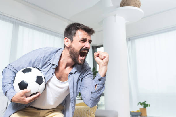 istock Young man holding football with winning gesture 1279973226