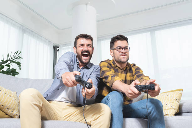 istock Two men playing video game at home 1279973577