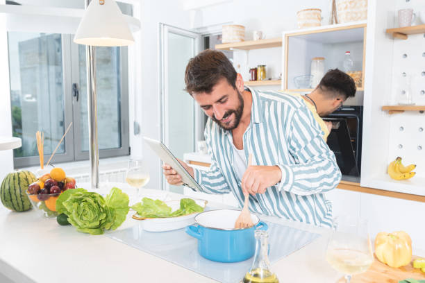 istock Two men cooking food in the kitchen 1279973591