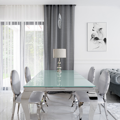 Glamour style glass and silver dining table with stylish chic chairs and charming lamp