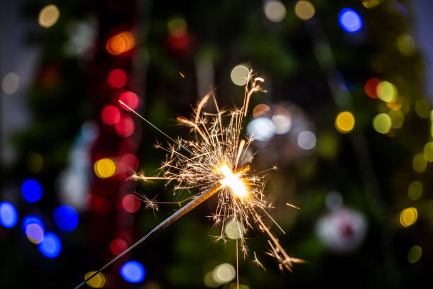 istock Sparkler and bokeh of Christmas tree on background 1279974045