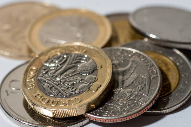 istock British pound coin and other currencies 1279974370